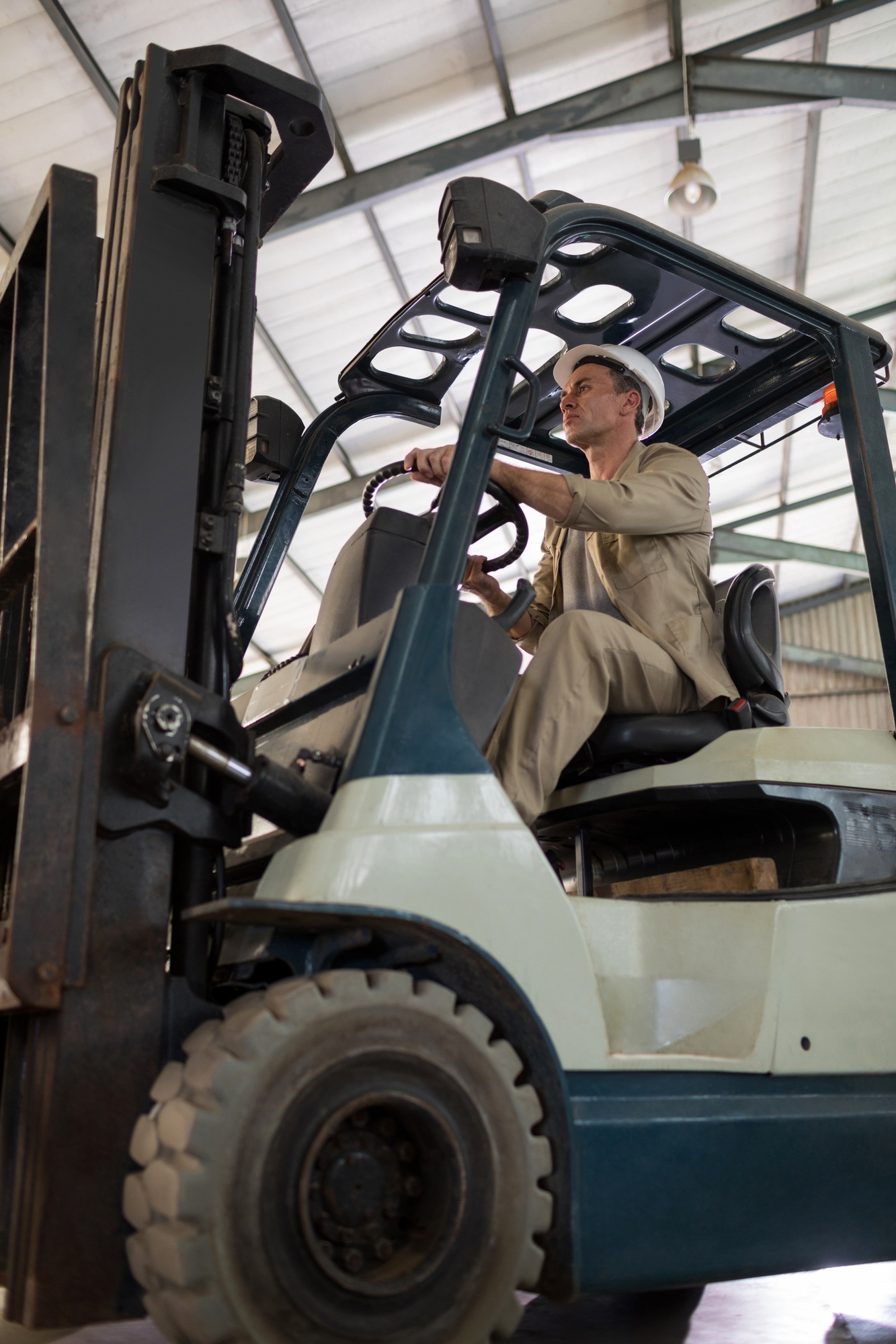 Worker driving forklift